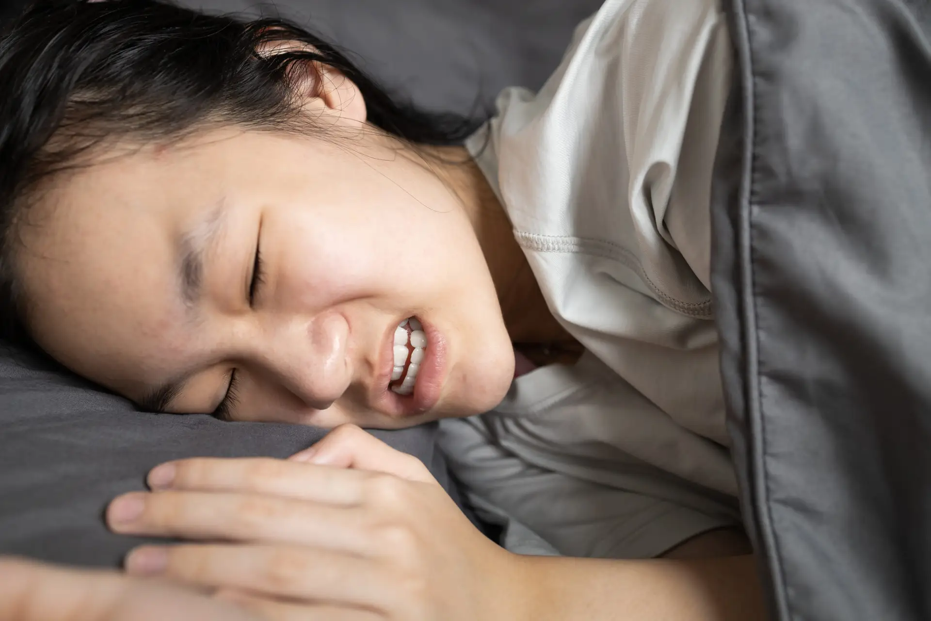 Girl who is grinding her teeth during sleep